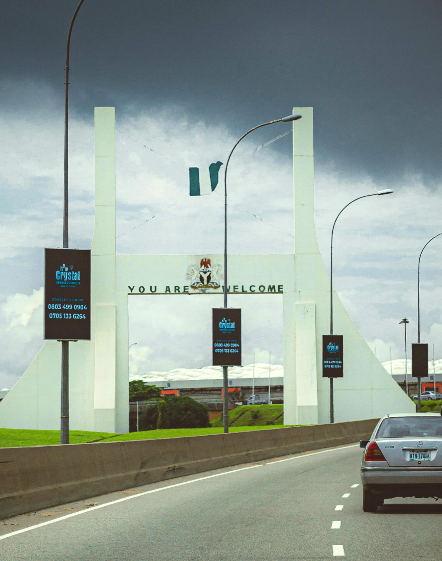 City Gate with Nigeria flag in Abuja, Nigeria saying "You Are Welcome", from International Media Buying: Nigeria